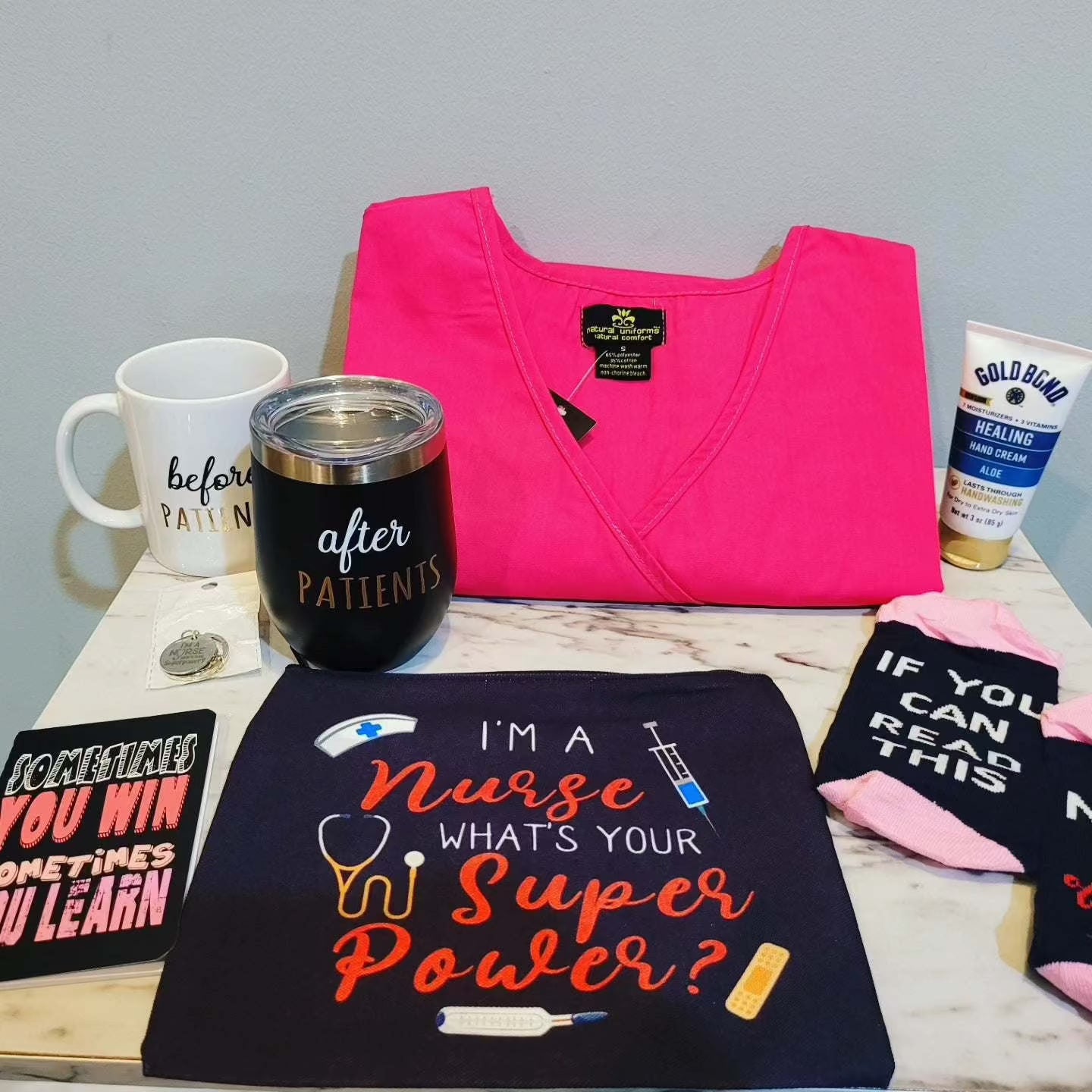 Gift basket for healthcare workers displayed with various items including a mug, compression socks, and uniform. The basket is arranged to showcase these thoughtful gifts for nurses and other healthcare professionals.