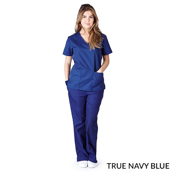 Female healthcare professional wearing true navy blue Mock Wrap Scrub Set. Image shows two front pockets on the scrub top, highlighting the set's functionality and comfort in a medical setting.