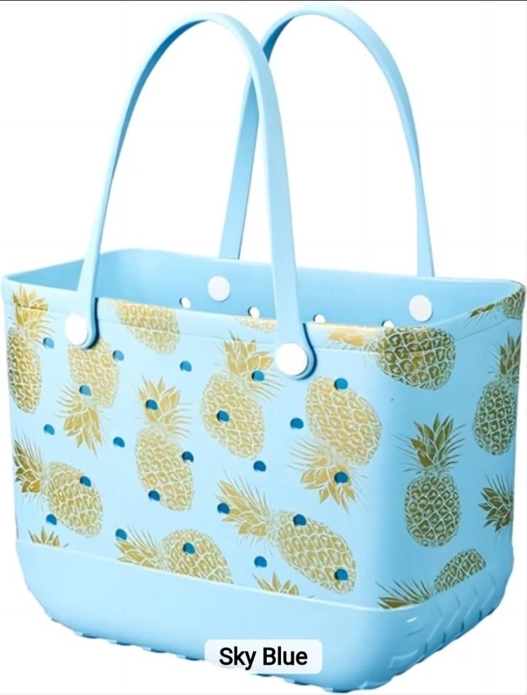 Light blue waterproof tote bag with golden pineapple print and sturdy handles